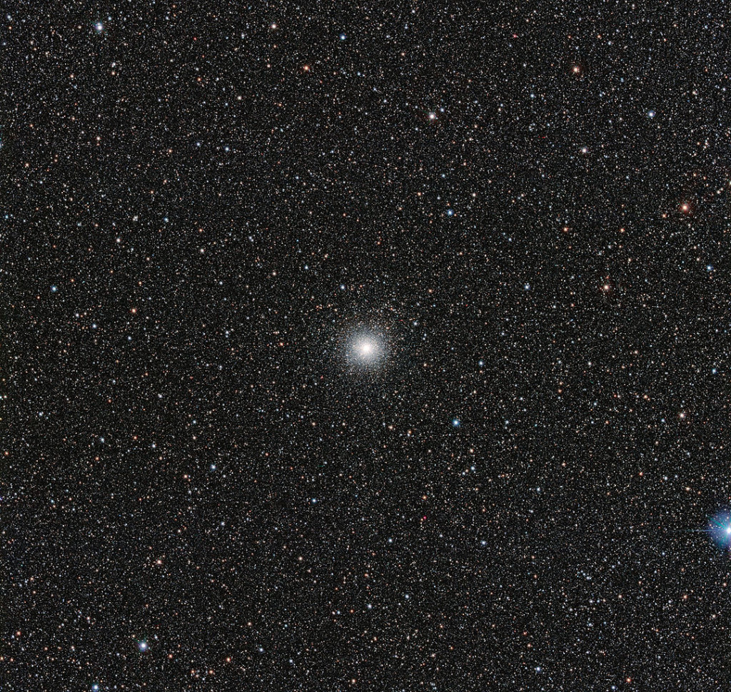 This image from the VLT Survey Telescope at ESO’s Paranal Observatory in northern Chile shows the globular cluster Messier 54. This cluster looks very similar to many others, but it has a secret. Messier 54 doesn’t belong to the Milky Way, but actually is part of a small satellite galaxy, the Sagittarius Dwarf Galaxy. This unusual parentage has allowed astronomers to use the Very Large Telescope (VLT) to test whether unexpectedly low levels of the element lithium in stars are also found in stars outside the Milky Way. Image: ESO, 2014.
